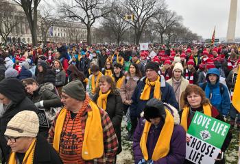 The group from St. Jane Frances de Chantal marches to urge people to choose life. Group members wear yellow scarves to identify one another and try to stay together. (Photo courtesy of Andrew Azan)