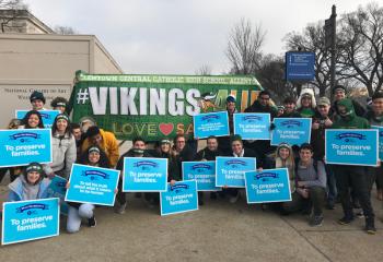 The group from ACCHS proclaims they march to preserve families, from left: front, kneeling Samantha Austin, Pollette Fierro, Yan Tavarez, Jamille Atiyeh, Miles Wagner, Michael Prebosnyak, John Sharpe, Abigail Misiak and Nicholas Amsler; middle row left of banner, Christine Wiktor, Olivia Wood, Joel Kerridge and Cristian Peralta; back, Anthony Wilson, Matthew Miller, Matthew Simcoe, Elbert Esquea, Grace Gilmore, John Borelli, Dylan Brown, Dan DiGiacomo, Evan Wirth, Ethan Meister and Noah Reimert. 