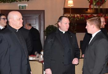 Chatting during the brunch are, from left, Monsignor Daniel Yenushosky, Father Christopher Butera and Tyler Loch.