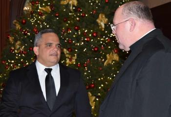 Juan Rodriguez, left, and Monsignor David James catch up at the brunch.