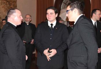 Father Christopher Butera, left, speaks with Alexander Brown, center, and Charles Carbonetto Jr.