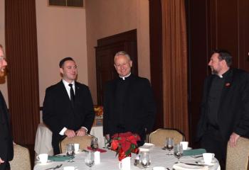 Preparing to sit down to brunch are, from left, Father Mark Searles, Philip Maas, Deacon John Maria, Father Adam Sedar and Deacon Giuseppe Esposito.
