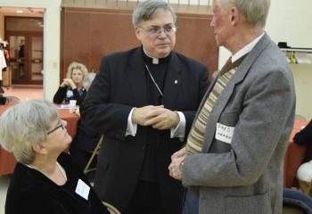 Bishop Schlert greets Fred Flemming and his wife, Sue at the light reception after Evening Prayer. 
