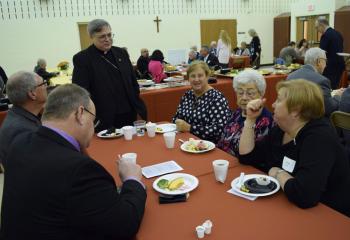 Bishop Schlert spends time with stewards at the reception.