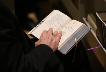 A bishop holds a prayer book during a service in the Chapel of the Immaculate Conception at Mundelein Seminary Jan. 2 at the University of St. Mary of the Lake in Illinois, near Chicago. The U.S. bishops began their Jan. 2-8 retreat at the seminary, suggested by Pope Francis in September, which comes as the bishops work to rebuild trust among the faithful as questions continue to revolve around their handling of clergy sex abuse. (CNS photo/Bob Roller)
