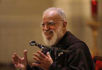 Capuchin Father Raniero Cantalamessa, the official preacher of the papal household, smiles as he speaks to U.S. bishops during a prayer service in the Chapel of the Immaculate Conception at Mundelein Seminary Jan. 2 at the University of St. Mary of the Lake in Illinois, near Chicago. The U.S. bishops began their Jan. 2-8 retreat at the seminary. (CNS photo/Bob Roller)