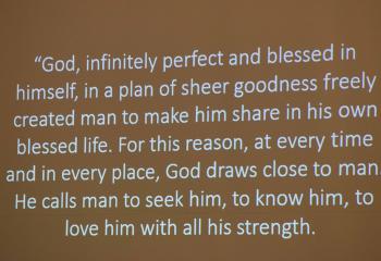 A slide from the “Catechism of the Catholic Church” reminds teens and their families that God wants to draw closer to them.