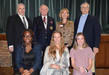 Overall division winners, Diocesan officials and guests are, from left: front, Kelechi Onuoha, second place Senior Division; Elizabeth Lieb, first place Senior Division; and Emma Martinez, first place Junior Division; back, Dr. Fromuth, John Philapavage, Mary Fran Hartigan and Father Andrew Torma.
