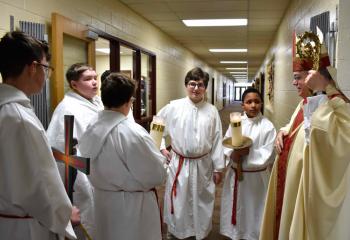 Bishop of Allentown Alfred Schlert, right, chats with the altar servers before celebrating Mass Jan. 28 to kick off CSW at St. Jerome Regional School (SJRS), Tamaqua. This year’s theme for CSW was “Catholic Schools: Learn. Serve. Lead. Succeed.” From left are Hunter Gallagher, Connor Rehnert, Dylan Newton, Anthony Odorizzi, and Brayden Segilia. (Photo by John Simitz)