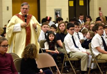 Bishop Schlert offers the homily during Mass at St. Jerome Regional School.“I am so proud of what you all have accomplished here in the Tamaqua area in just the course of the year. You’re here in a beautiful building that is new to you. A modern building that offers everything technology and learning can offer you, but most importantly what it offers you is your Catholic faith. It offers you the opportunity to learn about who Jesus is and how he should be and can be important in your life,” he said.