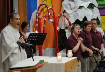 Father Bernard Ezaki, left, assistant pastor of St. Jane Frances de Chantal, Easton, celebrates Mass to kick off CSW at Mercy School for Special Learning, Allentown. Participating in the Mass are, from left: Sue Kaczmarek, music teacher; and students Brody Kleckner, Caroline Patruno and James Hebert. (Photo by Tara Connolly)