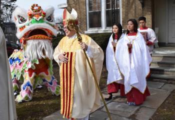 Bishop of Allentown Alfred Schlert joins the procession with the Mua Lan or “Lion Dancing” at SS. Simon and Jude, Allentown. 