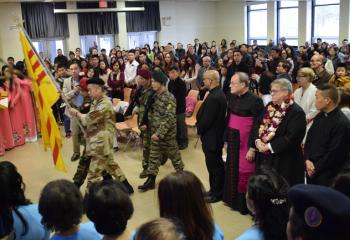 The Vietnamese American Freedom and Heritage Flag, with its three horizontal stripes paying homage to the three regions of Vietnam, is carried into the reception honoring other South Asian nations that observe the Lunar New Year.