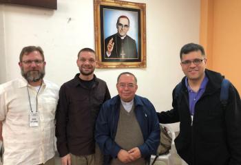 A priest for the Archdiocese of El Salvador, who knew Bishop Oscar Romero, third from left, meets with, from left, Father Laskowski, Father Ganser and Father Garcia-Almodovar.