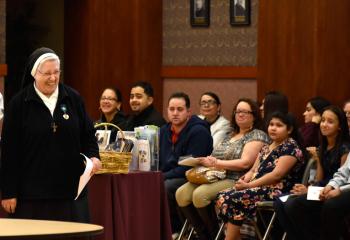 Sister Martha Zammatore, liaison for the Diocesan Office of Prison Ministry, welcomes catechumens to the Cathedral of St. Catharine of Siena, Allentown.