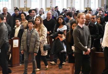 Catechumens and sponsors take their seats for the Rite of Election.