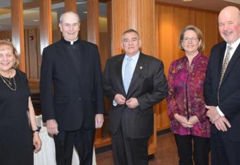 Monsignor Smith, second from left, is congratulated by, from left, Evelyn Carfagno, Anthony Carfagno, Dr. Linda Lapos and Paul Wirth.