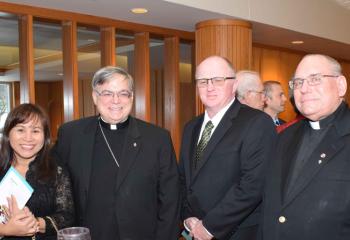 Bishop of Allentown Alfred Schlert, second from left, enjoys spending time with, from left, Norma Earley, Patrick Earley and Father Gregory Karpyn, assistant pastor of St. Patrick, Pottsville.