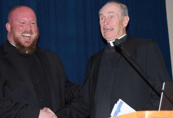 Father Allen Hoffa, left, pastor of St. Joseph, Summit Hill, enjoys a laugh with Monsignor Joseph Smith, gala honoree and pastor emeritus of St. Catharine of Siena, Reading.