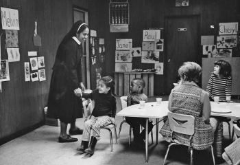 Sister Fabian Tucker helps teach English to children in 1970 at Kennedy House, Reading. (Photo courtesy of Kennedy House)