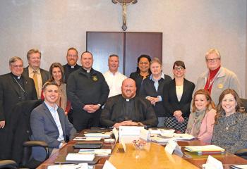 Members of the Lumen Christi Commission are, from left: front, Paul Marzen, Father Allen Hoffa, Tricia Christ and Wendy Krisak; back, Bishop Schlert, Robert Olney, Kari Mallozzi, Father Mark Searles, Father Christopher Butera, Deacon Peter Schutzler, Bernarda Liriano, Sister Meg Cole, Dr. Brooke Tesche and Alex Cirko.