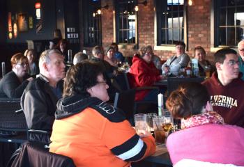 Adults gather at P.J. Whelihan’s, Reading for “Faith and Spirits.” 
