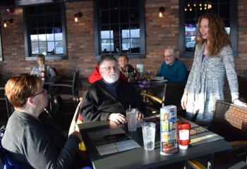 Maggie Riggins, right, talks to Michelle and Joseph Galantino, parishioners of St Mary, Kutztown, before the talk. 