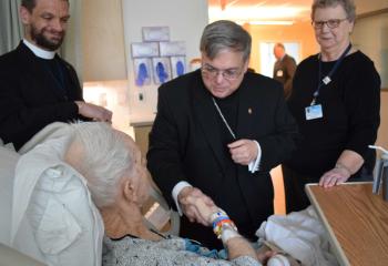 Bishop Schlert visits a patient with, Father Joseph Ganser, left, and Sister Rose Dvorak, a chaplain at PSHSJ. It was the Bishop’s first official visit as Bishop of Allentown to Penn State Health St. Joseph and part of the annual feast of St. Joseph activities at the medical center.