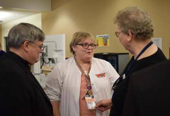 Bishop Schlert speaks with Joan Zupicick, clinical instructor at Reading Area Community College, center, and Sister Rose Dvorak.