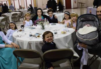 The Spear family, parishioners of the Cathedral of St. Catharine of Siena, Allentown, enjoy the evening, clockwise from left, Bernadette, Phoebe, Adelaide, Emily, Theodore, Veronica, Teresa, Michael holding Rosemary and Leo with his “best smile” on.