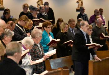 Faithful and supporters of BAA sing a song of prayer together.