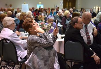 Monsignor William Baver, right, pastor of SS. Simon and Jude, Bethlehem, watches the BAA video with other supporters of the appeal.