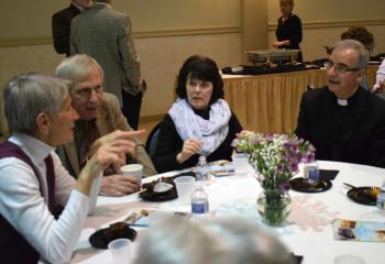Father Anthony Mongiello, right, pastor of St. Anne, Bethlehem, enjoys conversation with other BAA supporters at the reception.