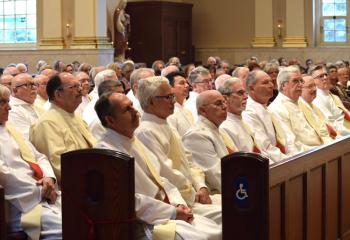 Members of the permanent diaconate listen to the homily preached by Bishop Alfred Schlert.
