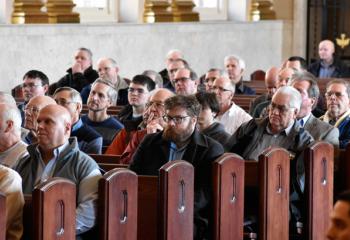 Men listen during the talk by Bishop Alfred Schlert.