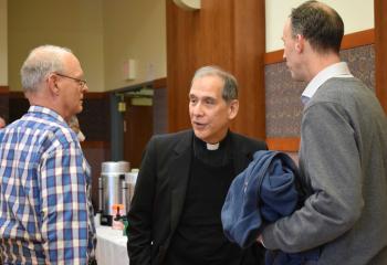Father Ezaki chats with Roy D'Ginto, left, and Tim Haring.