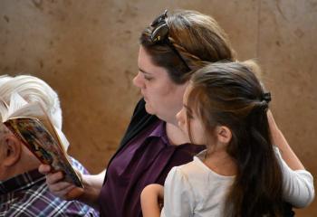 Among those participating in the Mass are Mary Reynolds and her 5-year-old daughter Charlotte.