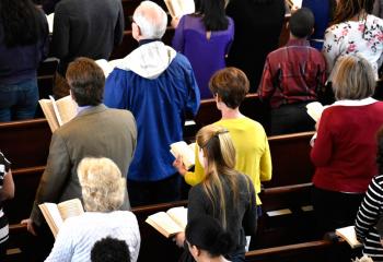 Parishioners read along with the Passion of Our Lord on the Feast of Palm Sunday.