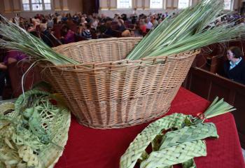 The basket of palms to be blessed and taken home by parishioners to symbolize Christ among them throughout the year.