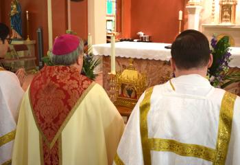 Bishop of Allentown Alfred Schlert venerates the first class relic of the 18th century saint. (Photo by John Simitz)