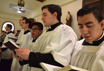 Seminarians for the Diocese of Allentown sing a hymn during the Mass. (Photo by John Simitz)