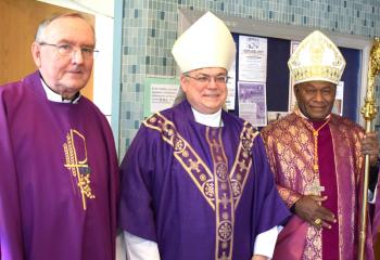Cardinal Ribat, right, meets with Father Kennedy, left, and Bishop Schlert during his visit to Holy Family.