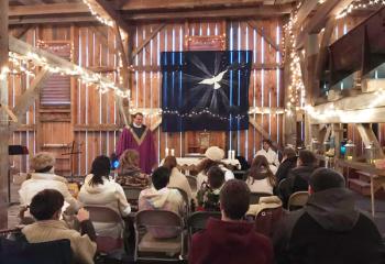Father Brian Miller, pastor of St. Joseph, Frackville, leads Eucharistic Adoration with teens on retreat at a farm in Zion Grove.