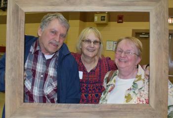 Rick and Deb Dasch, parishoners of St. Ambrose, are joined by Gail Braun, parishioner of St. Mary, Hamburg, center.