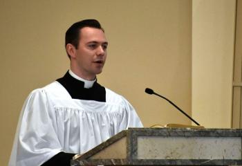 Seminarian Philip Maas proclaims the first reading at the Chrism Mass. (Photo by John Simitz)