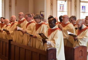 Priests renew their vows during the Chrism Mass, renewing their promise to serve the Lord and his Church, and unite themselves more closely to Christ in the service of his people.(Photo by John Simitz)