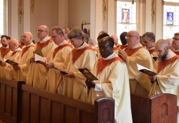 Priests renew their vows during the Chrism Mass, renewing their promise to serve the Lord and his Church, and unite themselves more closely to Christ in the service of his people.(Photo by John Simitz)