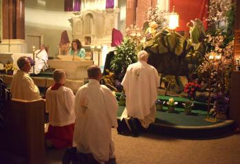 Kneeling in adoration at All Saints on Holy Thursday are, from left: Monsignor Andrew Baker; altar server Joseph Walko; and Monsignor William Baker. Christine Durso sings at left. Father Thomas Cappelloni is at far left at the altar. The Mass inaugurates the Easter Triduum that begins with Jesus’ Last Supper with his disciples. “The Eucharist is the cornerstone of the Catholic life. All things point to the Eucharist and the Church's entire life flows from the Holy Eucharist…,” said Bishop Alfred Schlert. 