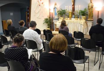 The faithful spend time with the Lord in silence on Holy Thursday April 18 at St. John XXIII, Tamaqua. It is a Lenten tradition to visit seven churches on the evening of Holy Thursday to adore the Blessed Sacrament, which is placed on the Altar of Repose after the Mass of the Last Supper. (Photo by John Simitz)