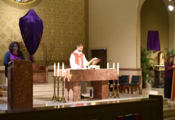 Father Joseph Ganser, assistant pastor of St. Joseph, Reading, celebrates a noon Mass on Good Friday April 19, commemorating the Passion of the Lord. Readers are Monica Krick, left, and Maria Wengyn, right. “Christ’s Passion gives us a model for the suffering that we experience in this life. He gives us the courage and strength to continue moving forward despite the seemingly heavy crosses that are placed on our shoulders,” said Bishop Alfred Schlert in a Good Friday message on social media. 